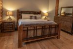 Retreat to the master bedroom with it`s cozy king size bed and beautiful reclaimed barn wood frame.